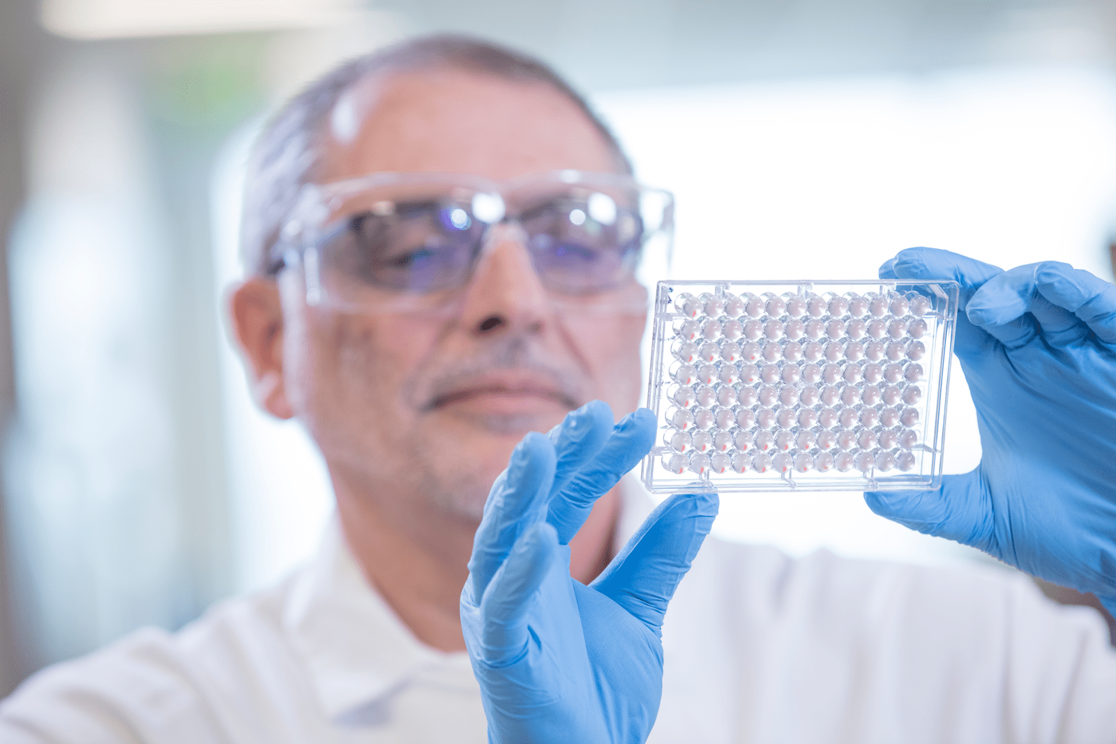 man holding a piece of medical equipment up in the light